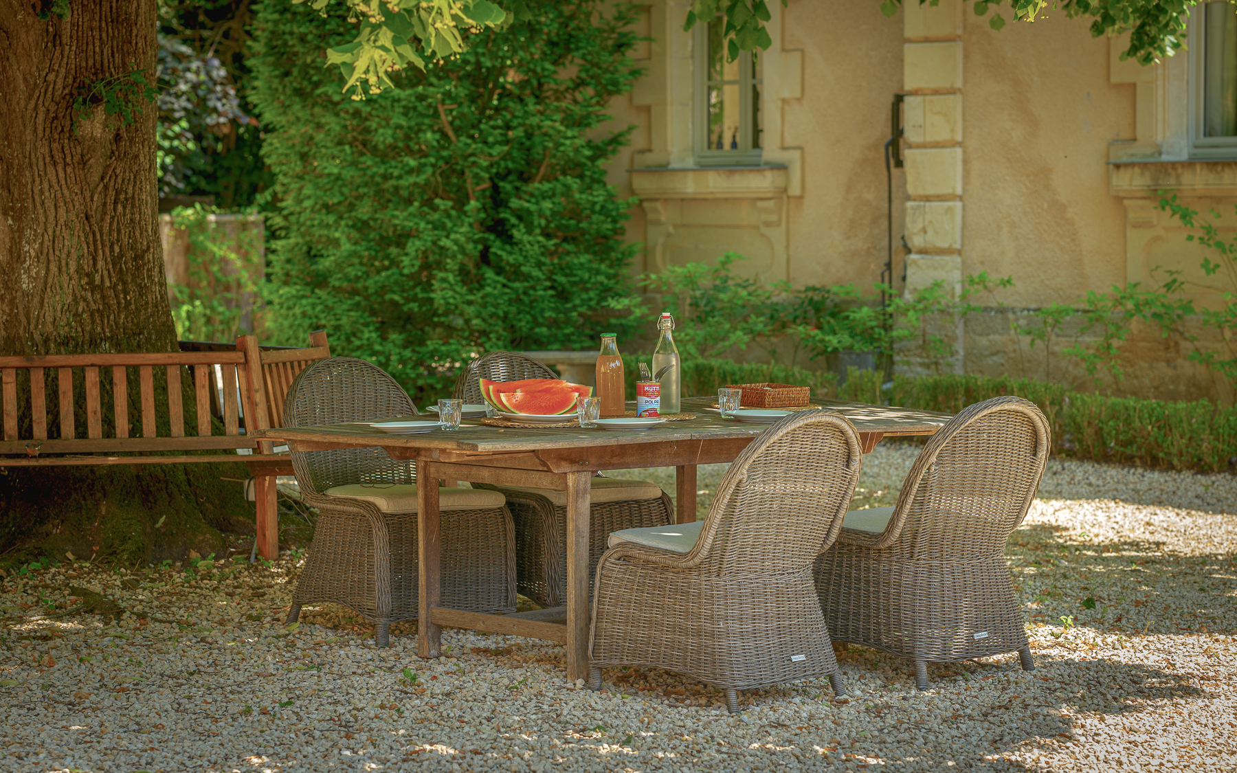 Outdoor dining under lime blossom tree